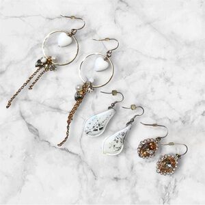 Gold and White Dangle Earrings Set with Intricate Design